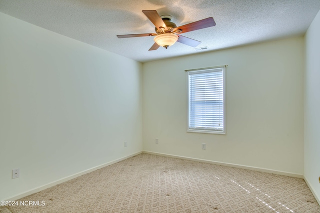 spare room with light colored carpet and ceiling fan