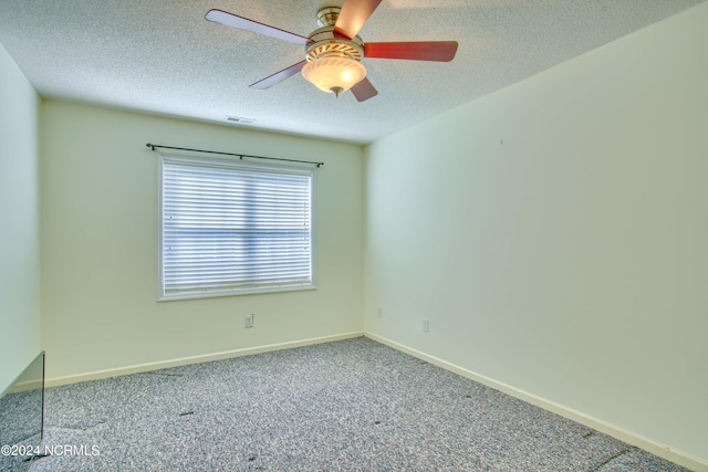 unfurnished room featuring carpet, a textured ceiling, and ceiling fan