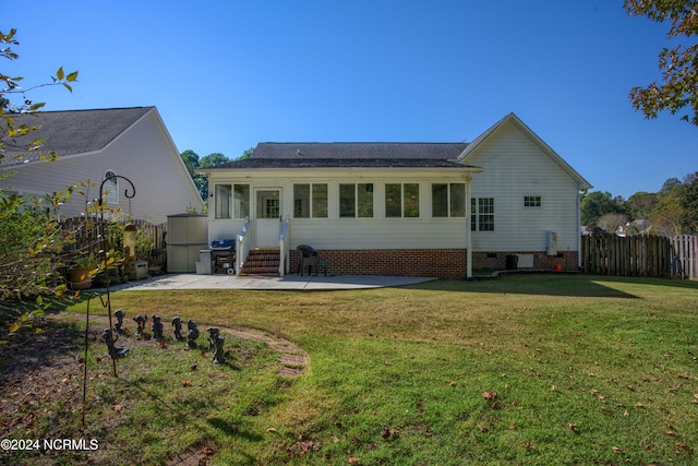 back of property featuring a lawn and a patio area