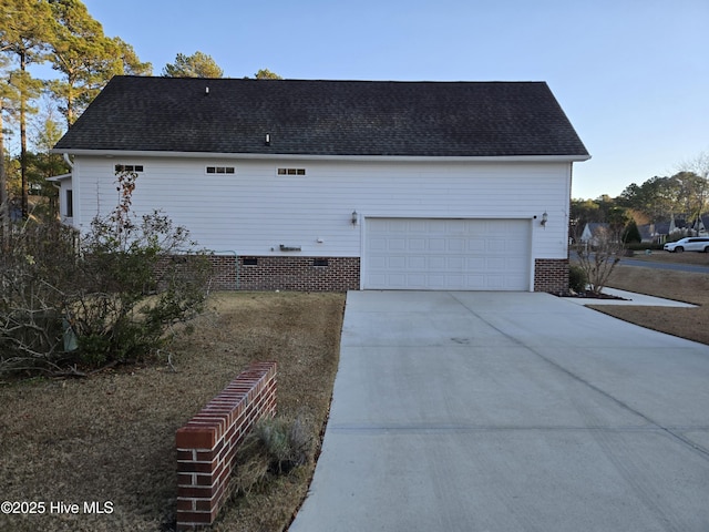 view of side of home featuring a garage