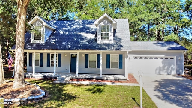4746 Rail Ct SW, Shallotte, NC 28470 - cape cod home with an attached garage, driveway, a porch, and a front lawn