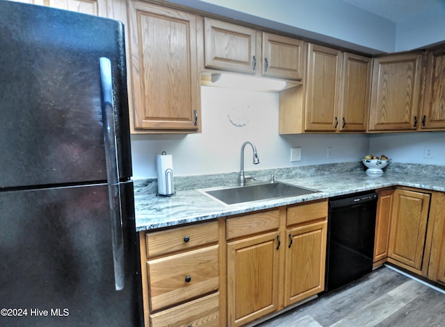 4746 Rail Ct SW, Shallotte, NC 28470 - kitchen with black appliances, light wood-style floors, and light stone counters