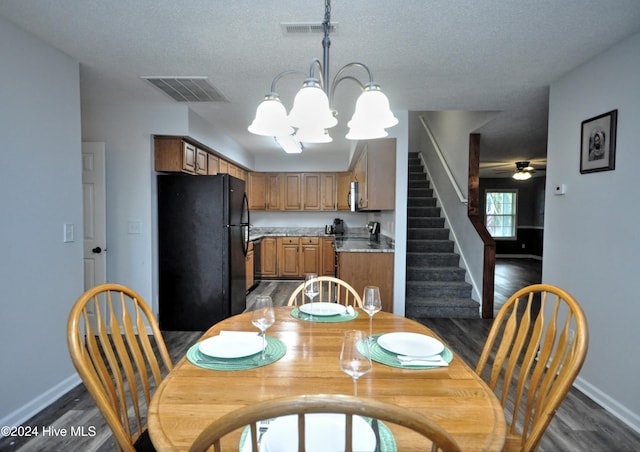 4746 Rail Ct SW, Shallotte, NC 28470 - dining room featuring dark wood-style floors, a chandelier, stairs, a ceiling fan, and a textured ceiling