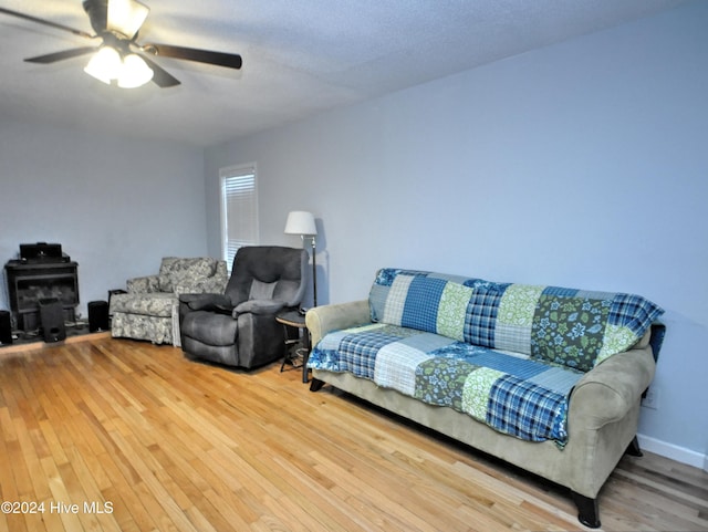 4746 Rail Ct SW, Shallotte, NC 28470 - living room with a ceiling fan, wood finished floors, and a wood stove