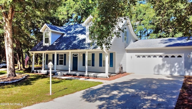 4746 Rail Ct SW, Shallotte, NC 28470 - cape cod-style house featuring driveway, covered porch, an attached garage, and a front yard