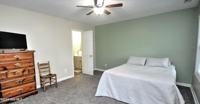 4746 Rail Ct SW, Shallotte, NC 28470 - bedroom featuring dark colored carpet, connected bathroom, and a ceiling fan
