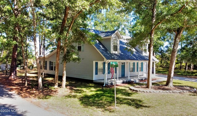 4746 Rail Ct SW, Shallotte, NC 28470 - cape cod house featuring covered porch and a front lawn