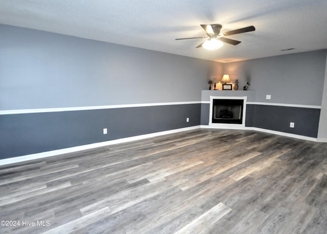 4746 Rail Ct SW, Shallotte, NC 28470 - unfurnished living room featuring ceiling fan, a fireplace, and wood finished floors