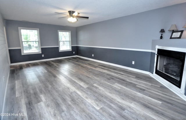 4746 Rail Ct SW, Shallotte, NC 28470 - unfurnished living room featuring wood finished floors, a fireplace, and a ceiling fan