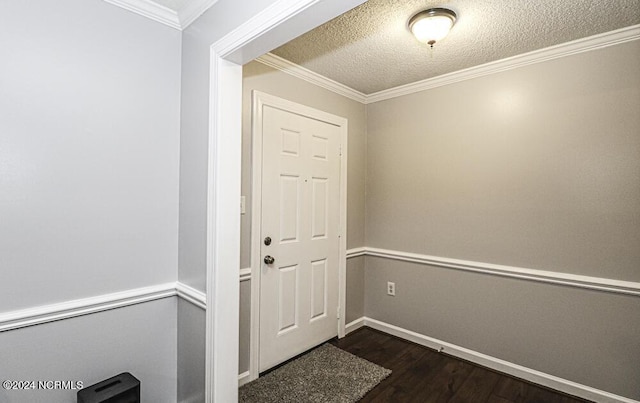 doorway to outside with a textured ceiling, dark hardwood / wood-style floors, and ornamental molding