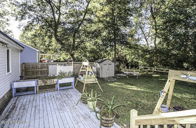 wooden terrace with a lawn and a storage shed