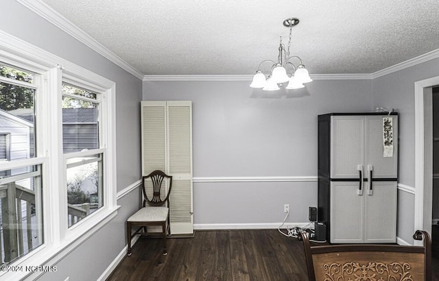 interior space with dark hardwood / wood-style flooring, an inviting chandelier, a textured ceiling, and ornamental molding