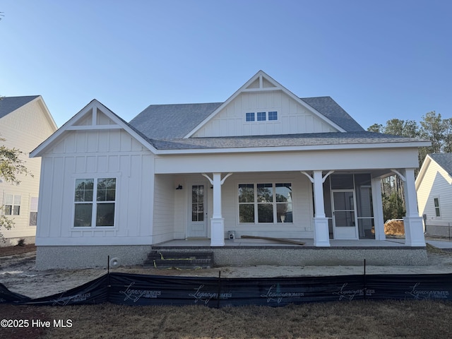 view of front of property featuring a shingled roof, a porch, and board and batten siding