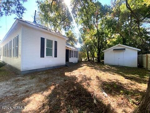 view of side of property with a storage unit