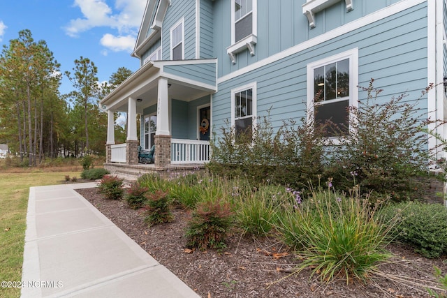 view of exterior entry with covered porch