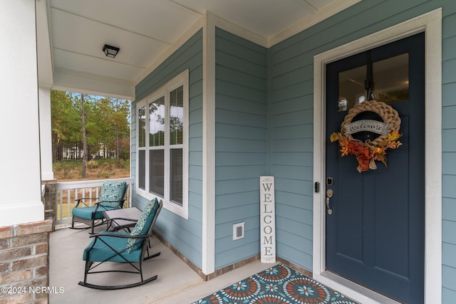 entrance to property featuring a porch