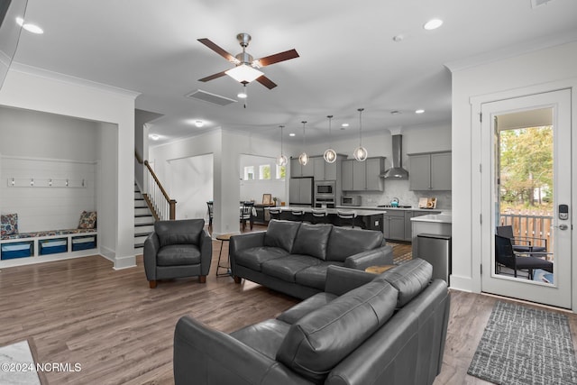 living room with crown molding, ceiling fan, and dark hardwood / wood-style flooring