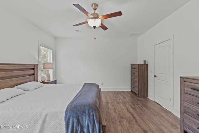 bedroom with hardwood / wood-style flooring and ceiling fan