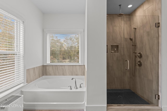 bathroom with plenty of natural light and plus walk in shower