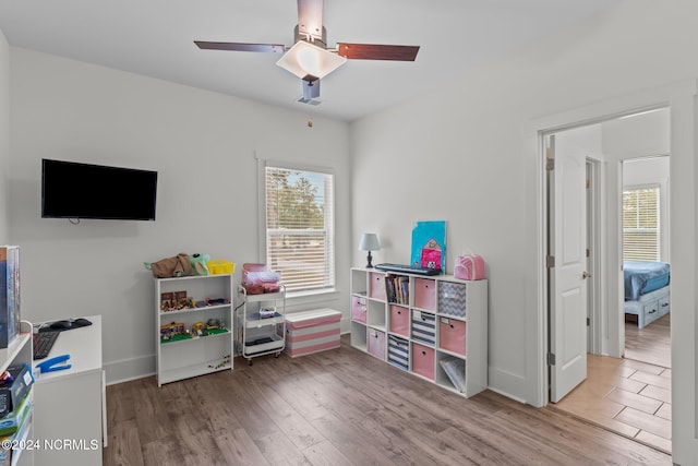 playroom with hardwood / wood-style floors and ceiling fan