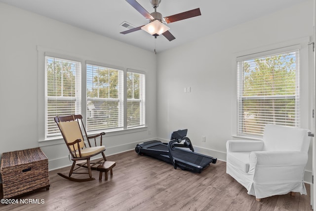 sitting room with ceiling fan and hardwood / wood-style floors