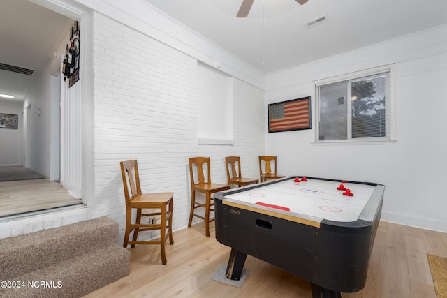 playroom with light hardwood / wood-style floors and ceiling fan