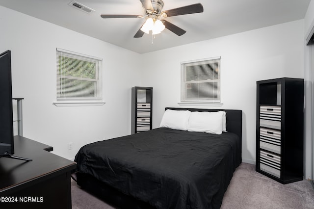 bedroom with ceiling fan and light carpet