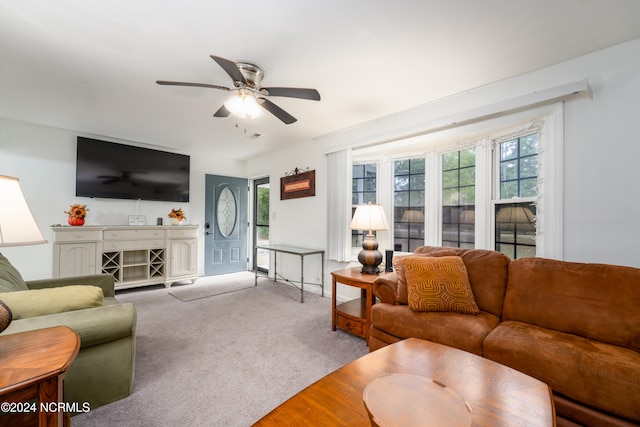 living room featuring light carpet and ceiling fan