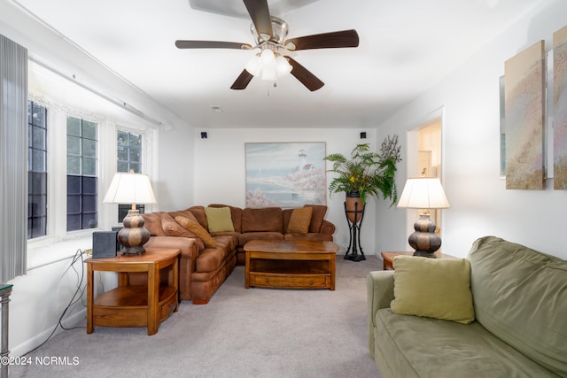 carpeted living room featuring ceiling fan