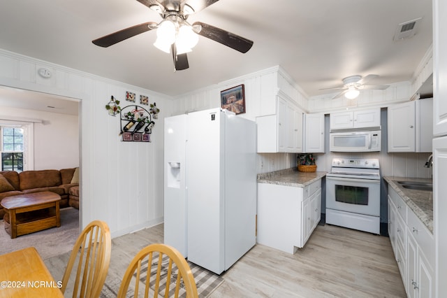 kitchen featuring white appliances, crown molding, light hardwood / wood-style flooring, and white cabinets