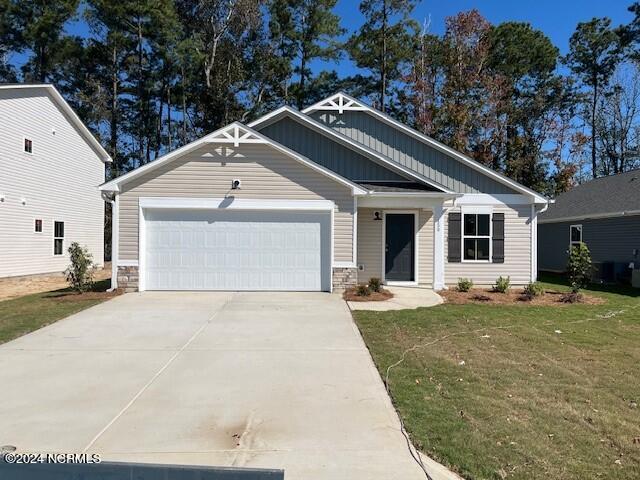 craftsman-style home with a garage and a front lawn