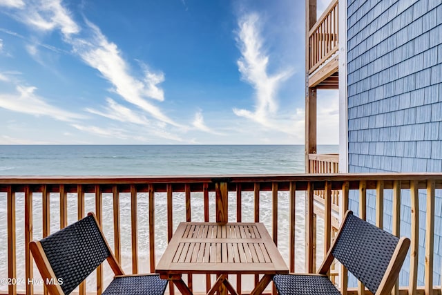 balcony with a deck with water view and a beach view