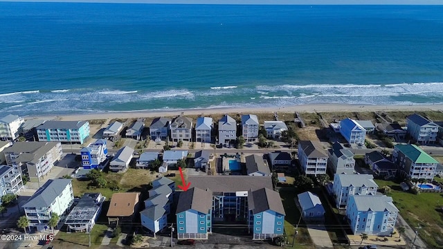 birds eye view of property with a beach view and a water view