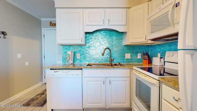 kitchen featuring white cabinetry, sink, and white appliances