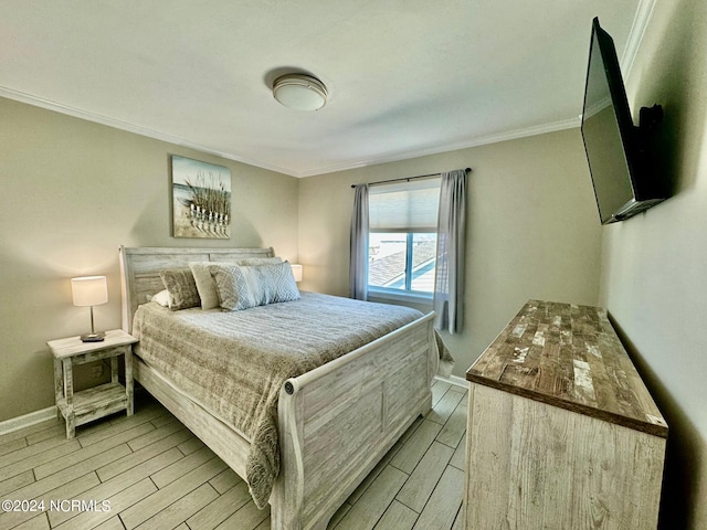 bedroom with light hardwood / wood-style flooring and ornamental molding