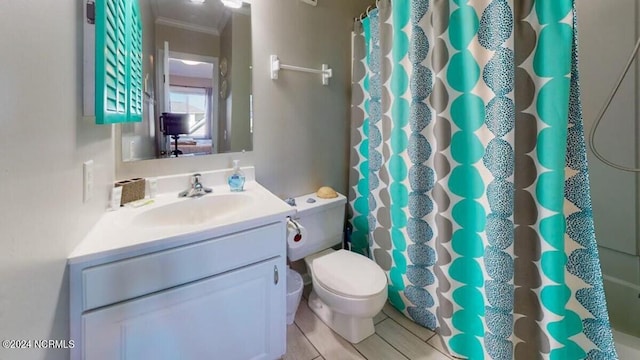 bathroom featuring vanity, toilet, curtained shower, and crown molding