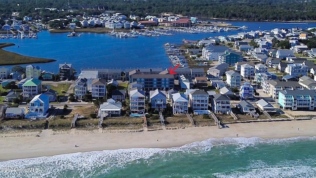 drone / aerial view featuring a water view and a view of the beach