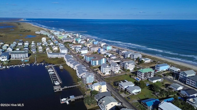 birds eye view of property with a water view and a view of the beach