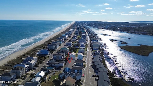 drone / aerial view with a beach view and a water view