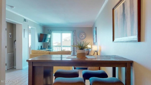 dining area featuring ornamental molding