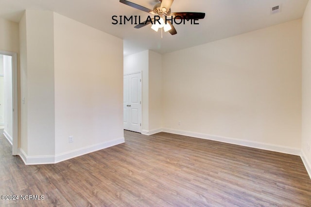 spare room featuring hardwood / wood-style flooring and ceiling fan