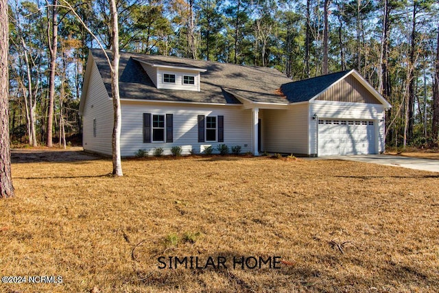 view of front of home with a front yard and a garage