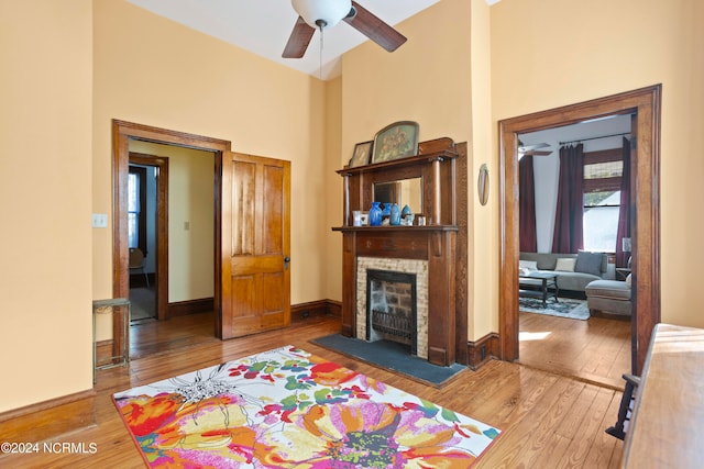 living room featuring ceiling fan and hardwood / wood-style flooring