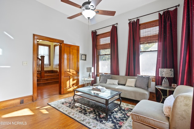 living room featuring ceiling fan and hardwood / wood-style floors