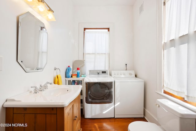 bathroom featuring vanity, washer and clothes dryer, wood-type flooring, and toilet