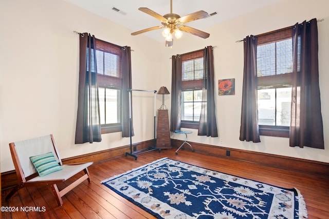 sitting room with hardwood / wood-style flooring and ceiling fan