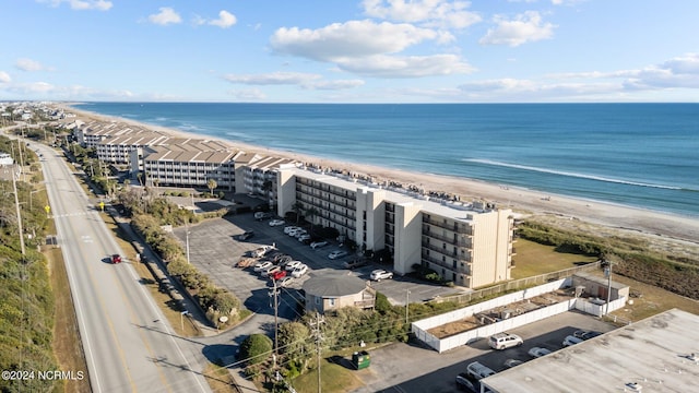 birds eye view of property with a view of the beach and a water view