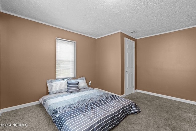 carpeted bedroom with ornamental molding and a textured ceiling