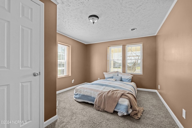 bedroom featuring a textured ceiling, ornamental molding, and carpet flooring