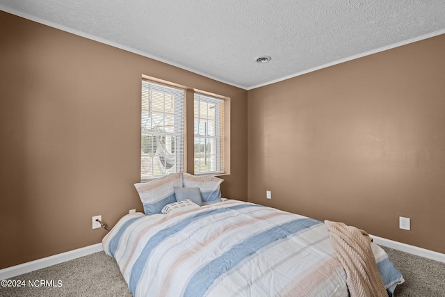 carpeted bedroom featuring a textured ceiling and crown molding